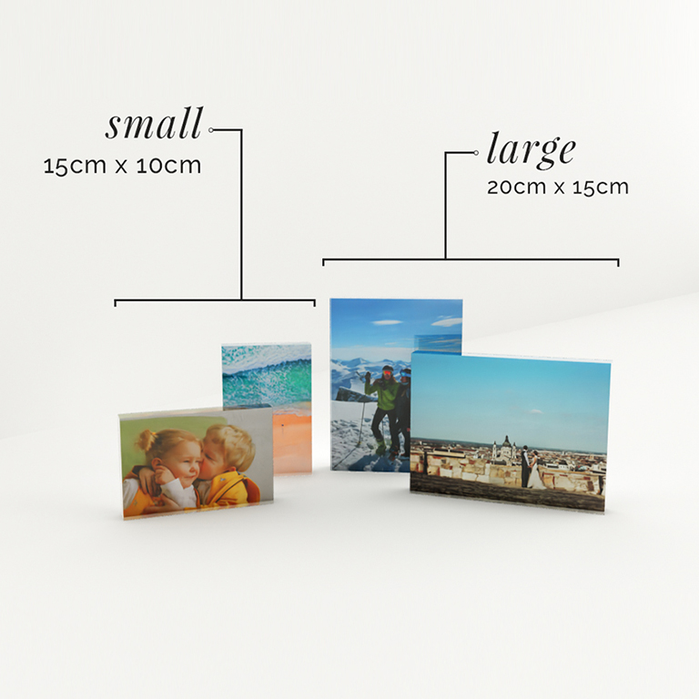 Arrangement of four acrylic photo blocks, three standing and one laid down showcasing the beautiful clarity of the block