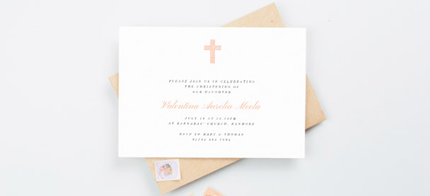 A religious christening invitation. This is a landscape christening invite card with a light orange, modern crucifix design.