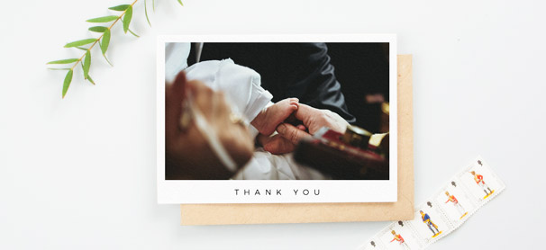 A simple christening thank you cards with a large baptism photo. “Thank you” is written in capitals at the bottom of the card.