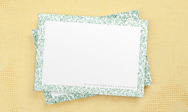 Personalised note cards with green leaf floral border on yellow table cloth