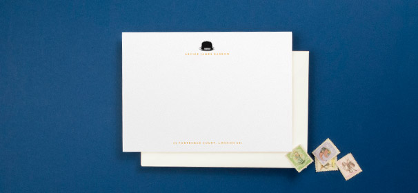 A personalised note card designed for a man. It has a black bowler hat icon at the top of the card, and the gentleman’s name and address in orange.