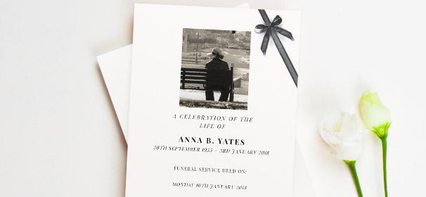 An 8-page funeral order of service booklet. This funeral service program has a photo of the loved one at the top, and a printed black ribbon.