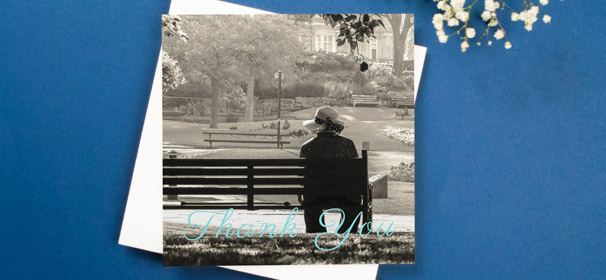 A funeral thank you card design with a blue, cursive “Thank you” written over a full-page photo.