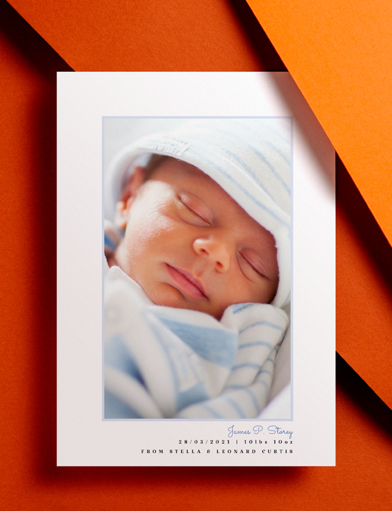 Baby Birth Announcements A baby birth announcement card with printed toy animals sat on a brown envelope. The card shows a photo and birth details of a new-born baby girl.