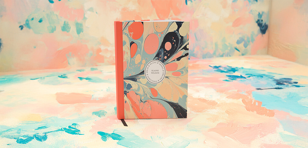 Personalised notebook with marbled cover design on colourful pastel background