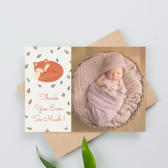 A landscape baby thank you card with a sleep fox surrounded by autumn leaves. It reads “Thank you ever so much”. There is a picture of a baby girl to the right-hand side.