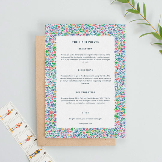 A floral wedding insert sheet containing information on an upcoming wedding. The information font is blue and classic.