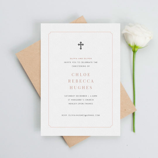 A classic christening invitation card with a religious crucifix in the top middle of the invite. There is a pink notch border and the information for a baby girl’s christening in the middle
