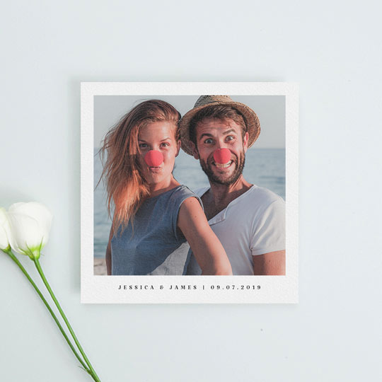 A simple, square wedding save the date card with photos. It has one single, colour photo with the names of an engaged couple printed in black underneath. The bottom of the photo save the date also has the date of an upcoming wedding.