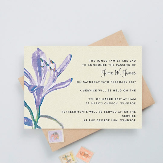 A floral funeral announcement card with a watercolour painted purple flower on the left, and the details of a funeral service on the right of the card.