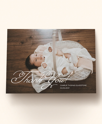 A photo baby thank you card named `flourished thank you`. It is printed in landscape format.