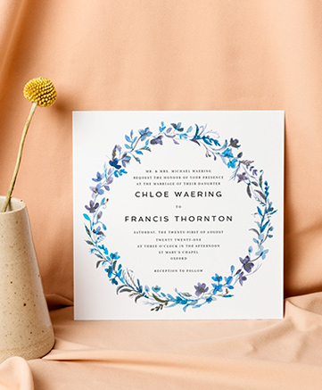 A watercolour wedding invitation named `blue floral wreath`. It is printed in square format.