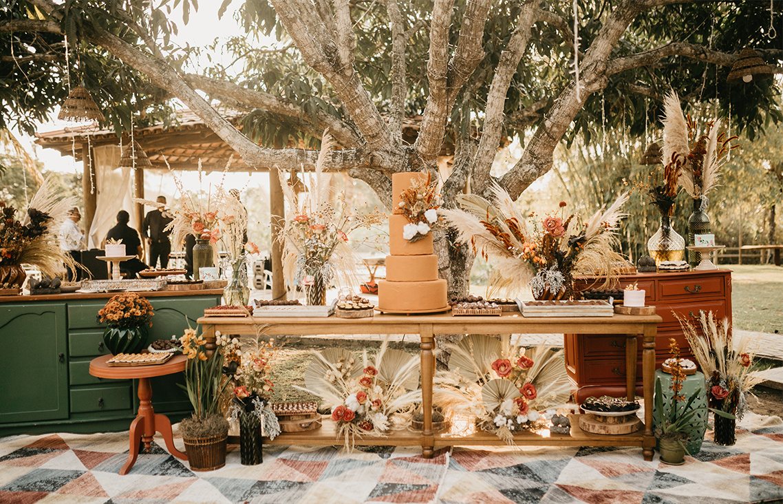 Photo of a botanical-looking wedding setup outside.