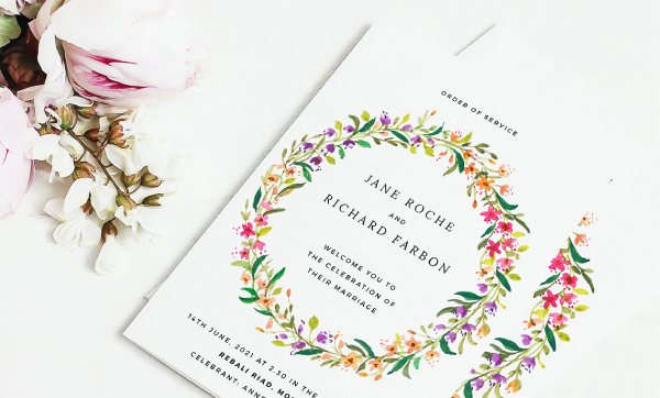 A beautiful, premium wedding order of service. Watercolour floral design with oranges, purples and pinks. Black text. Multi-page order of service.