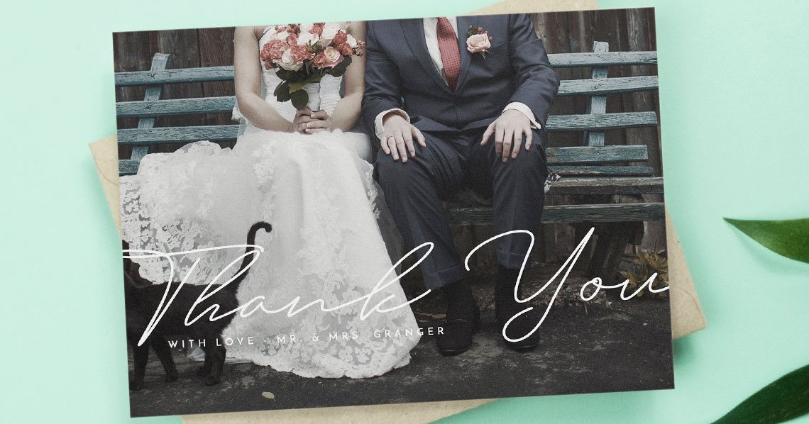 A simple photo wedding thank you card on a turquoise background.