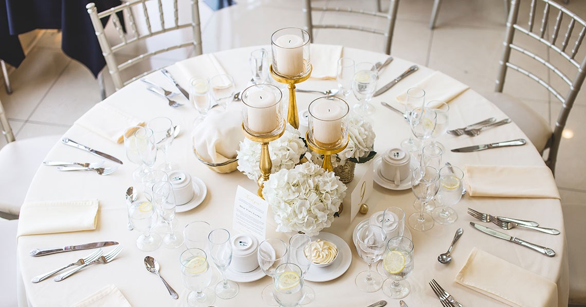 Elegant wedding reception table setup with beautiful centerpiece and fine diningware. Elegant wedding reception table setup with beautiful centerpiece and fine diningware.