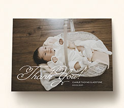 A landscape, folded baby thank you card printed with full photo