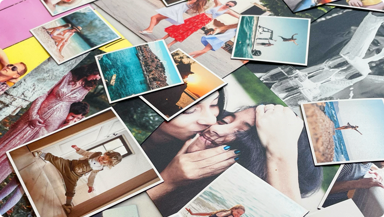 Diverse photo fridge magnets on table, showcasing family, wedding, holiday, and pet photos.