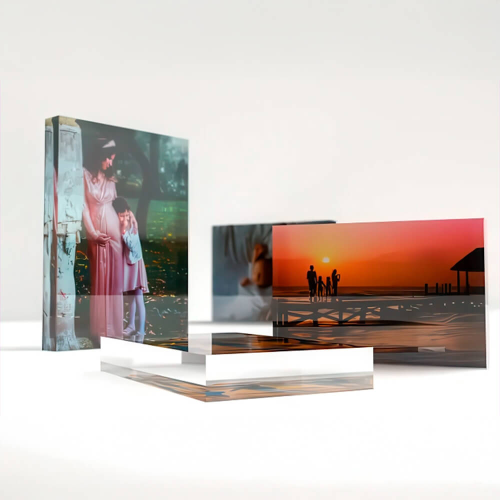 Acrylic photo blocks featuring a variety of personal and family moments, including children and sunset scenes, displayed on a neutral white surface