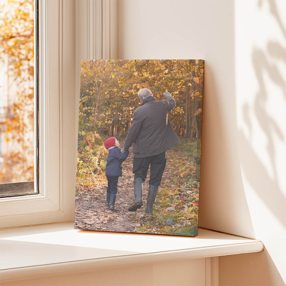Canvas photo print of a grandparent and child walking through autumn woods, leaning against a window ledge in natural light — ideal as a memorial keepsake