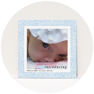 Blue floral birth announcement with close-up baby photo and introducing text