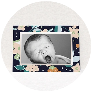 Navy floral border birth announcement with black and white newborn photo