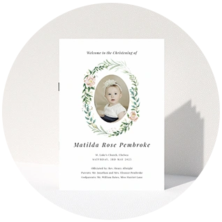 Christening order of service with central photo framed by soft greenery and florals