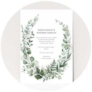 Boho-style engagement party invite with green foliage wreath and elegant serif text