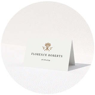 Gold place card with minimalist floral crest and date