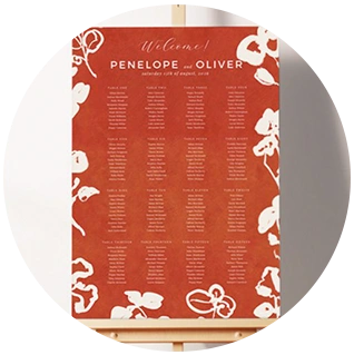 Modern wedding table plan with red background and white floral accents