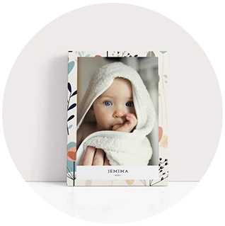 Floral edge canvas print with close-up baby portrait and name text